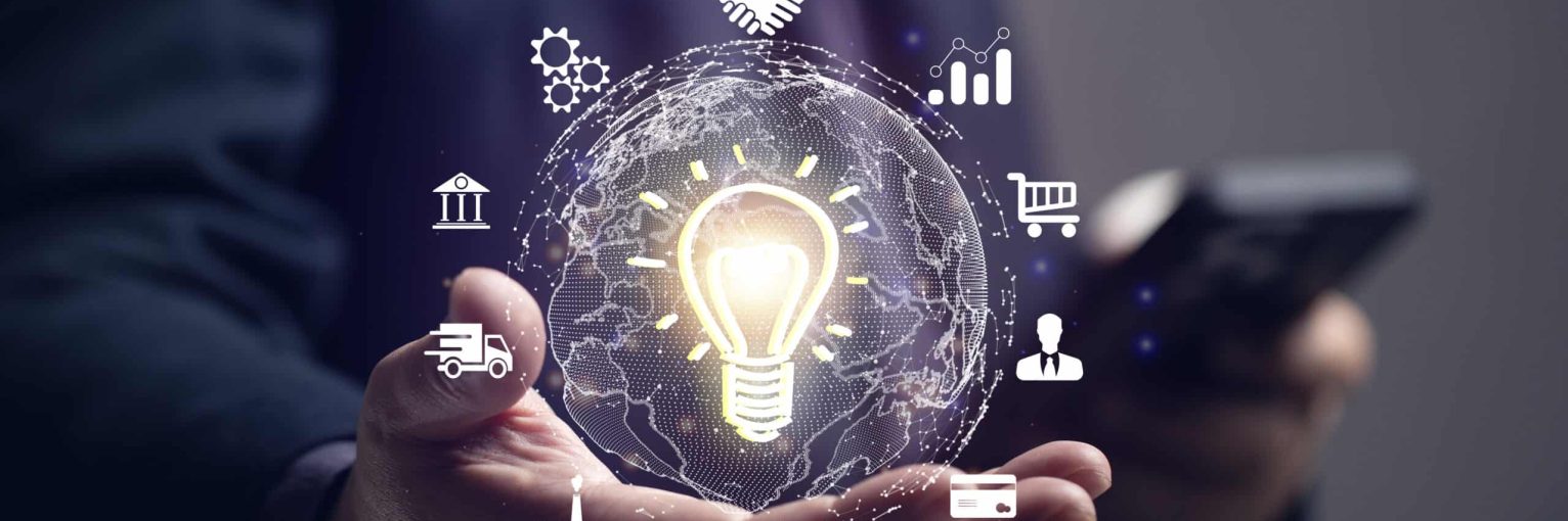 Businessman holds a light bulb and has a virtual globe connected by the internet. Marketing in the digital age via mobile, finance, banking, online marketing, industry, education, big data.